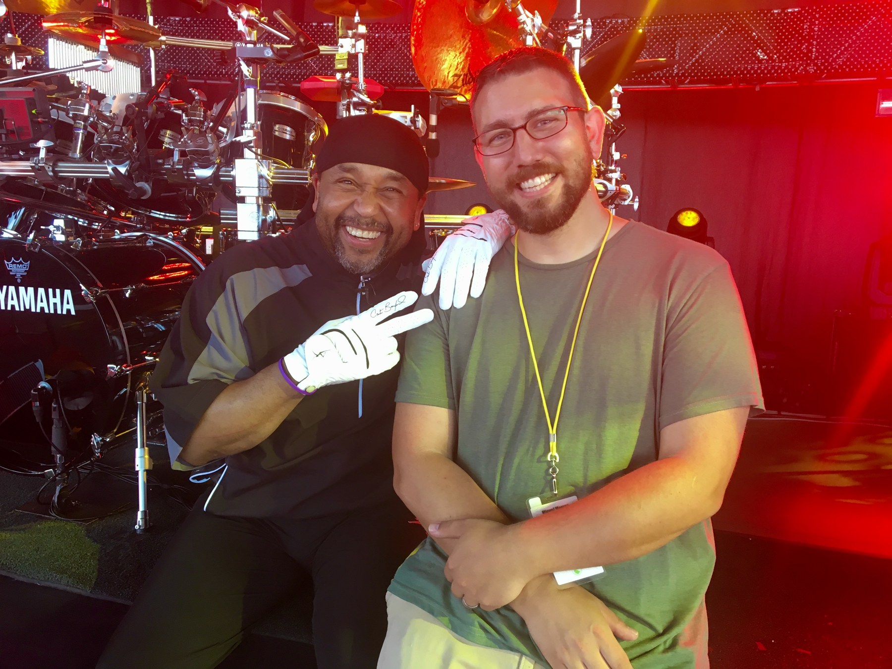 Miguel with Carter Beauford in front of a drum kit.